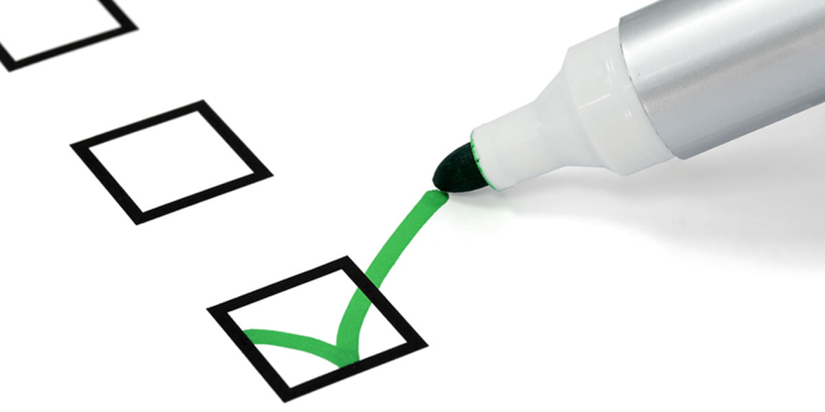 A green marker completing a checkbox.
