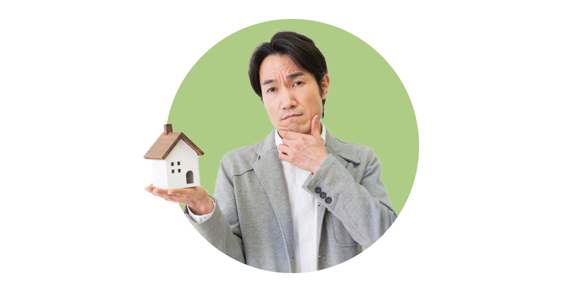 Man holding small house